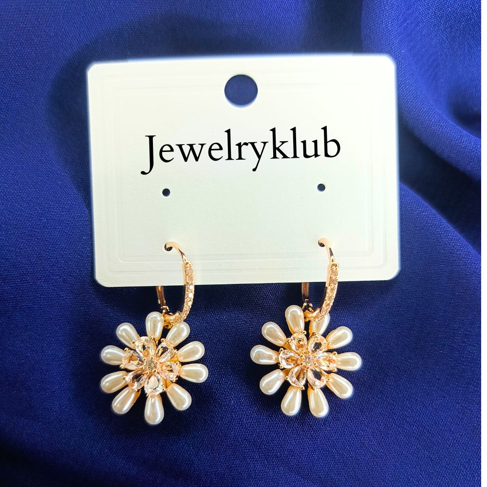 Gold-plated daisy drop earrings with pearl petals and crystal centers, perfect for weddings, brunches, or stylish everyday looks.