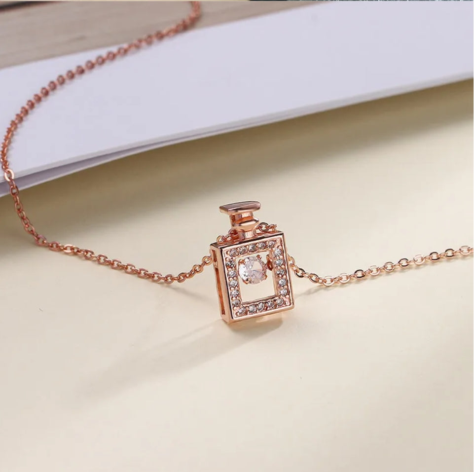 Dancing Diamond Perfume Bottle Shape Pendant With Chain - Rose Gold