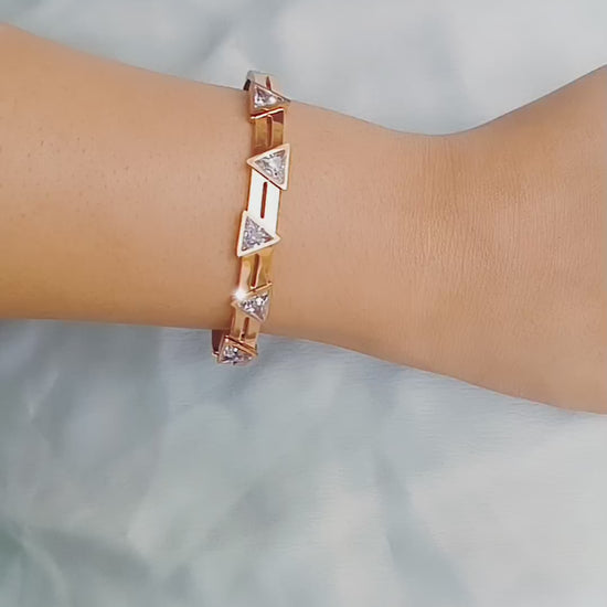 Rose gold bracelet with triangle-cut cubic zirconia stones, minimalist geometric design, perfect for stacking or wearing solo, modern chic jewelry accessory.