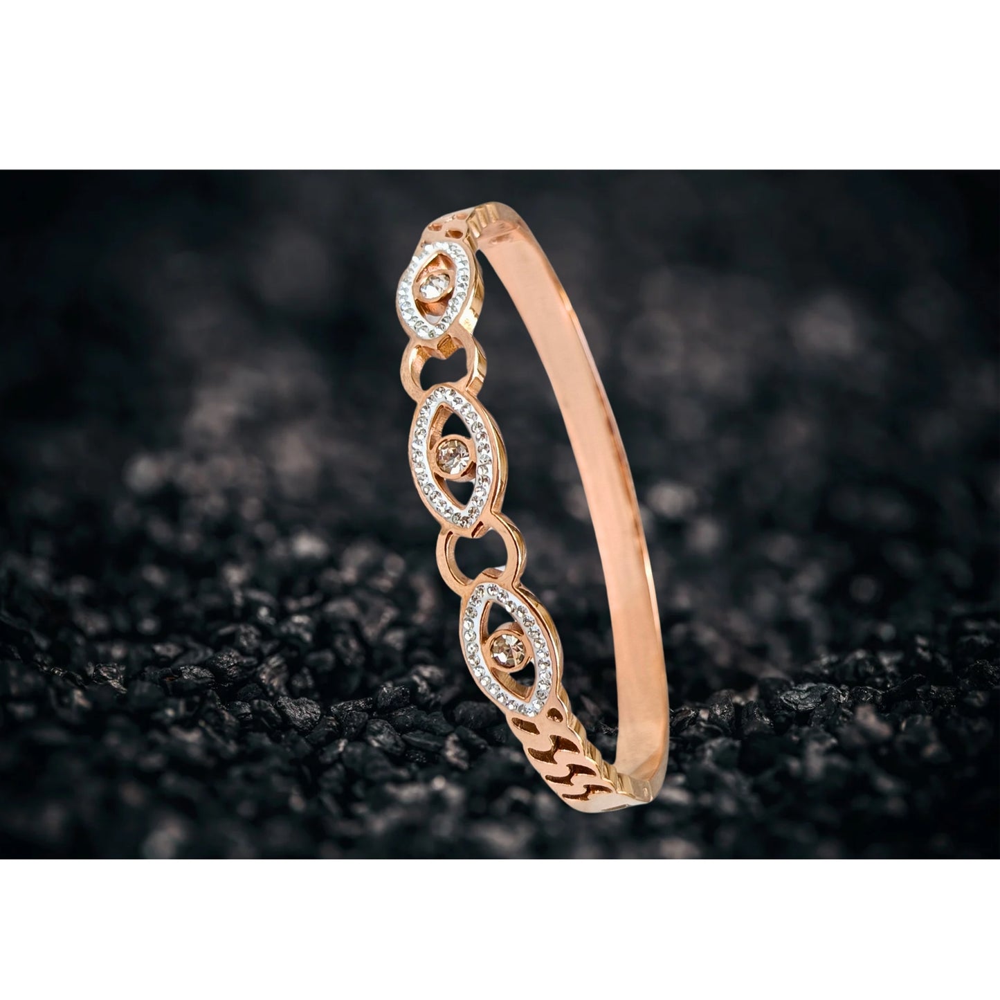 Rose gold evil eye bangle bracelet with intricate crystal detailing, featuring protective eye motifs and a sleek, shimmering finish.